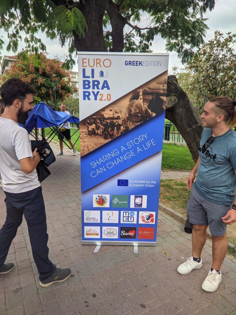 Two participants with a Eurolibrary roll up banner