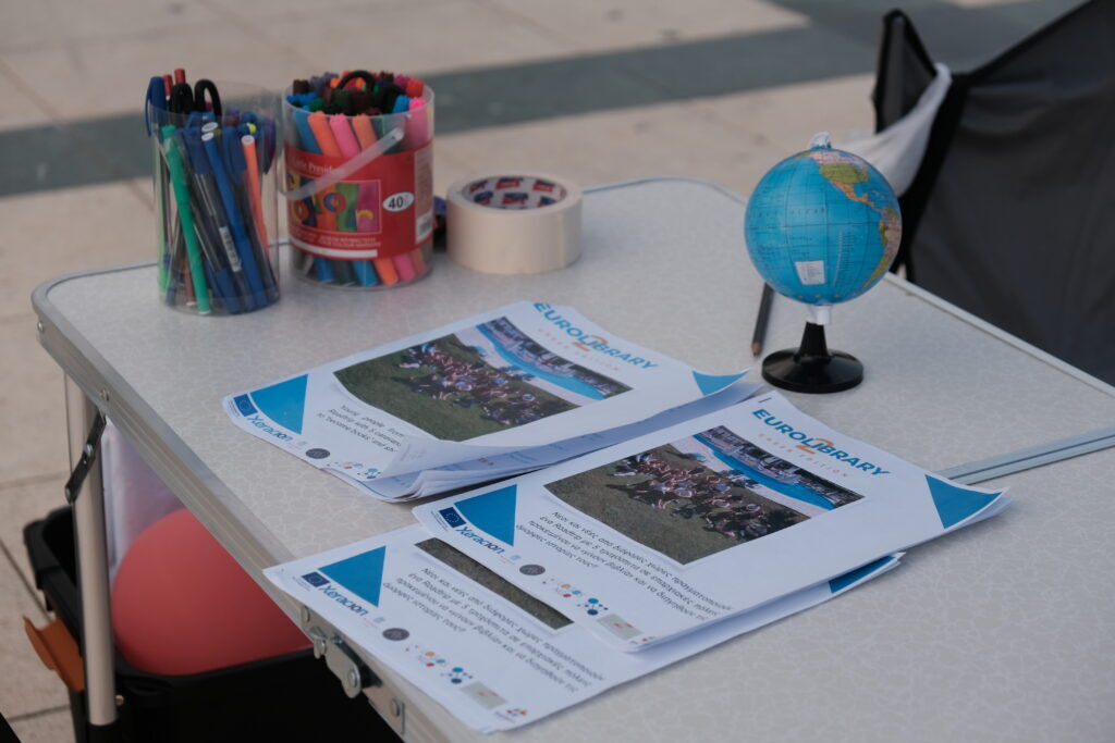 An information table with leaflets and a small globe