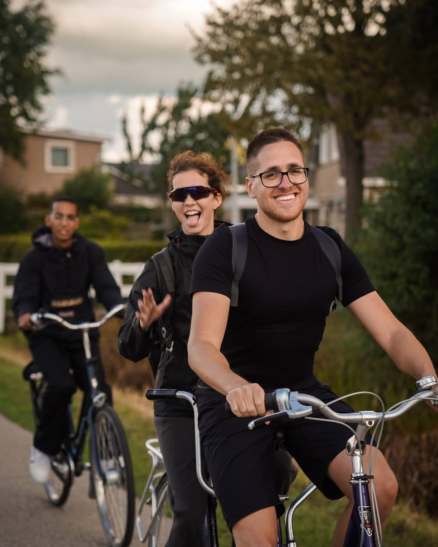 Three participants smiling on their bikes
