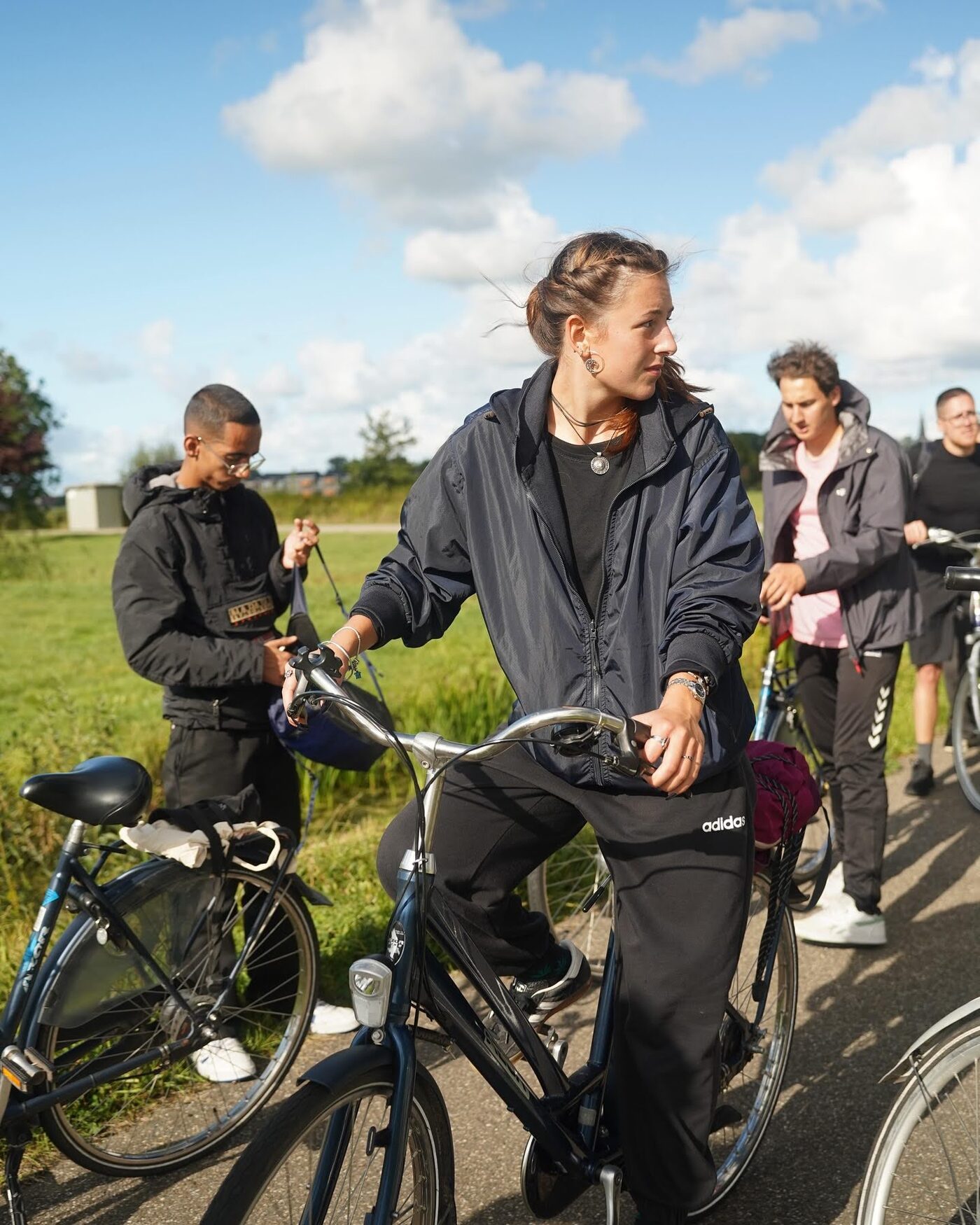 Cyclists riding side by side in the Frisian countryside