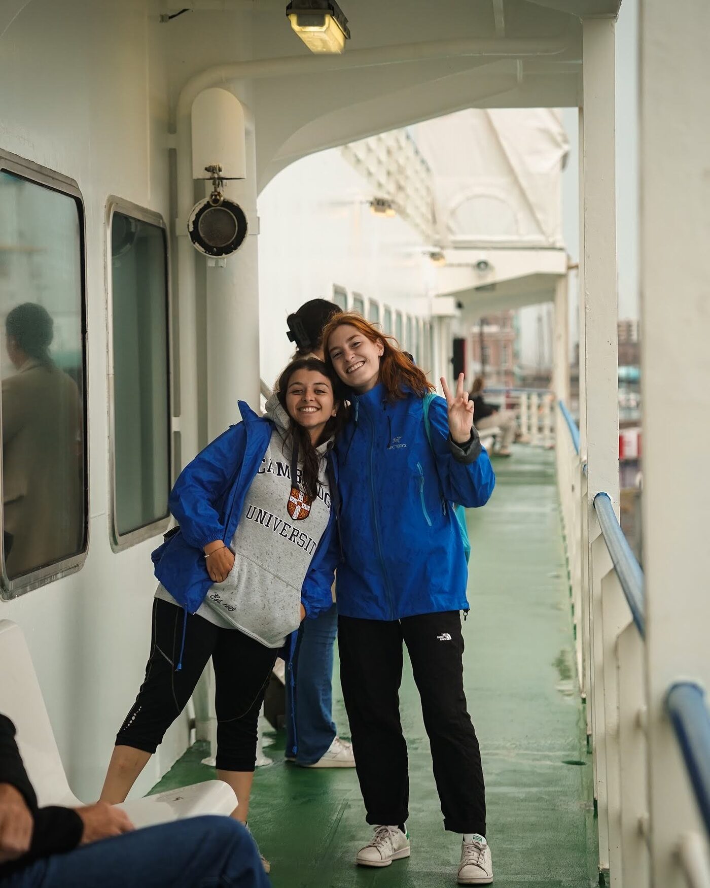 Two participants hugging in a ferry corridor