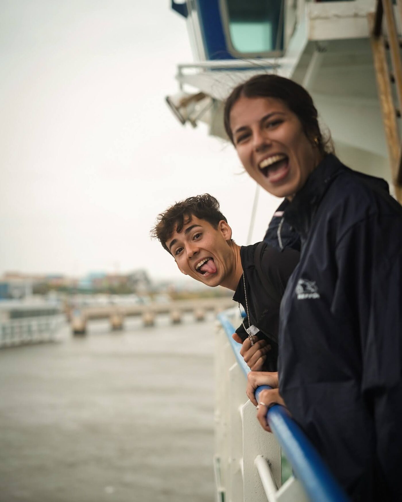 Two participants laughing on the deck of a ferry