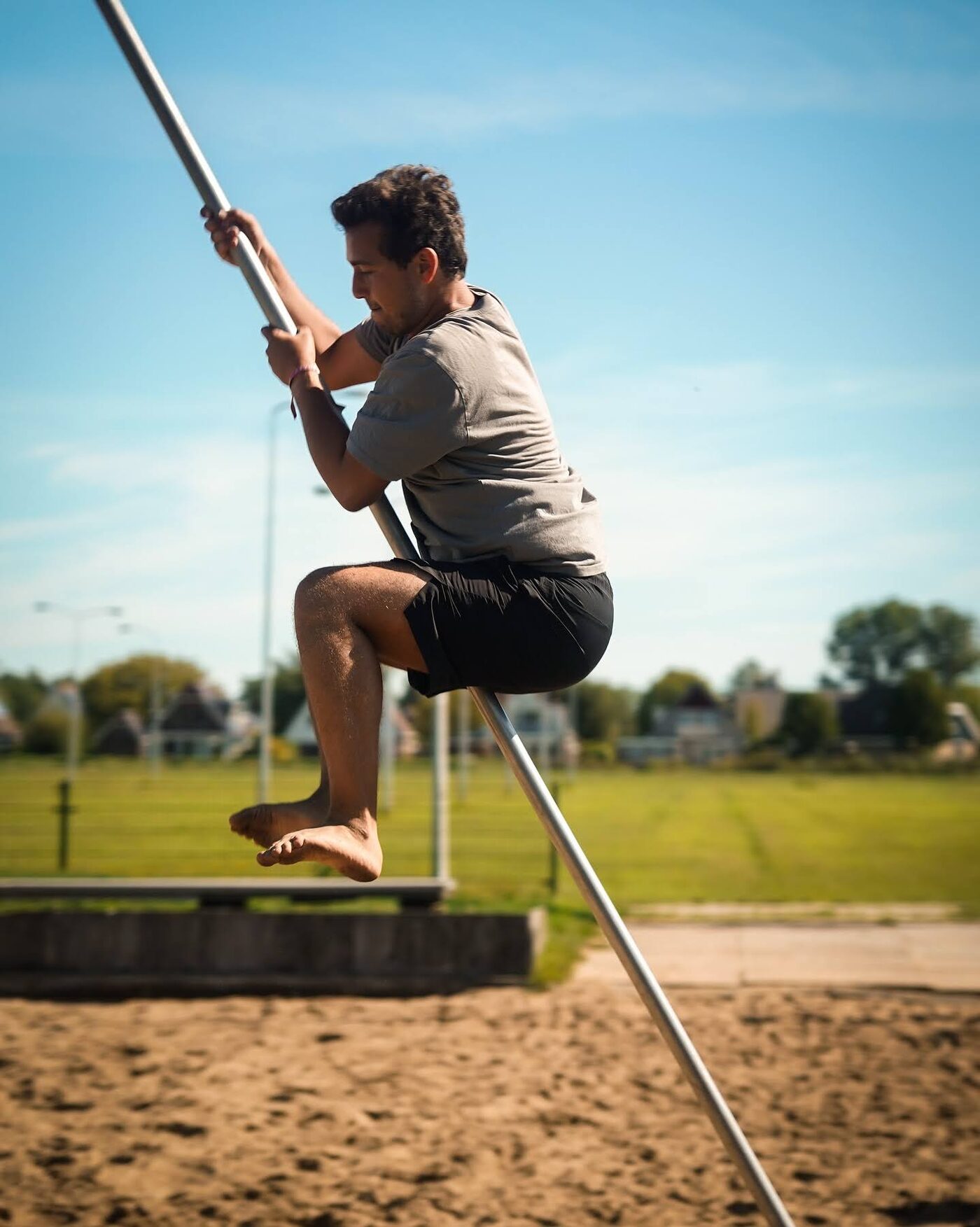A participant pole vaulting over a canal