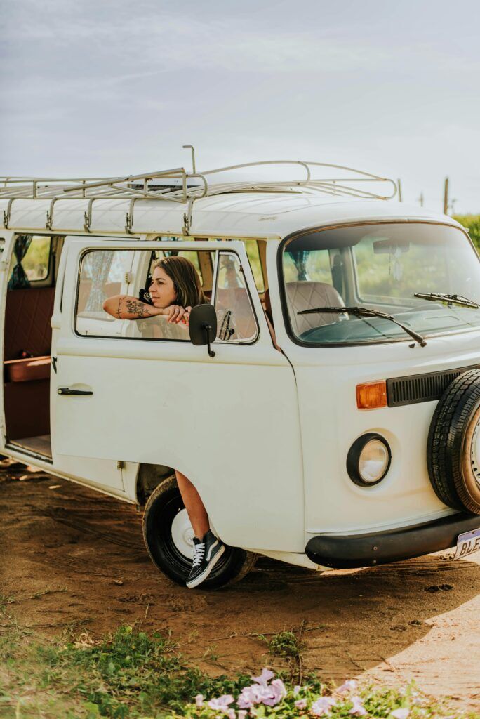 A person looking out of a vintage campervan