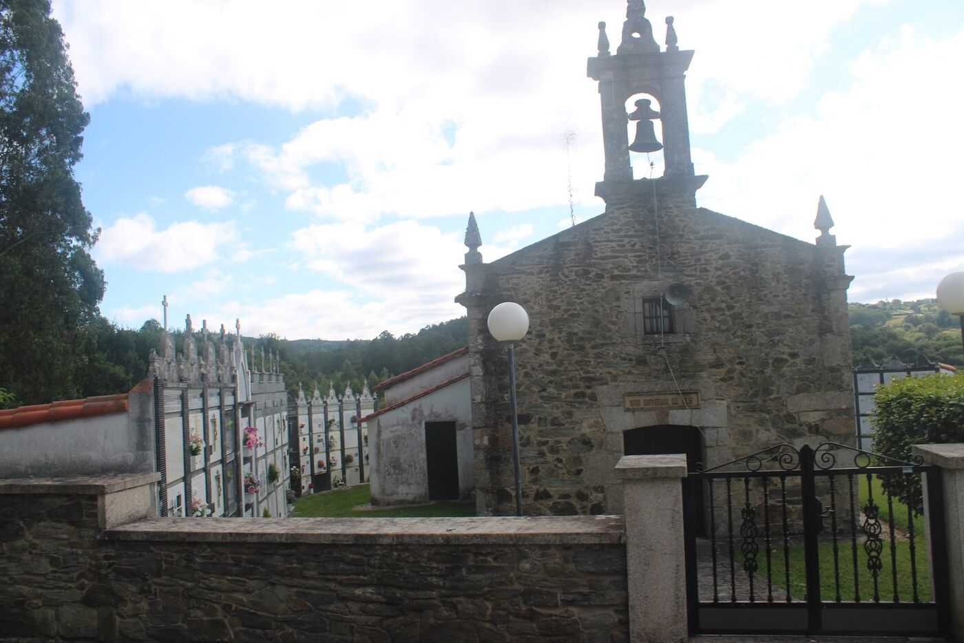 A stone chapel with a bell tower in the Galician countryside