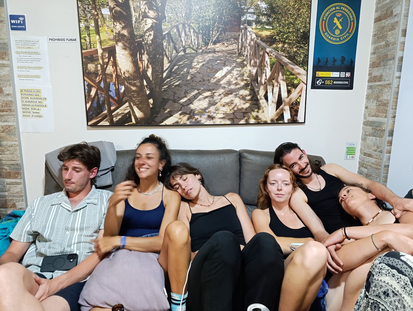 The group resting together on a sofa after a day of walking