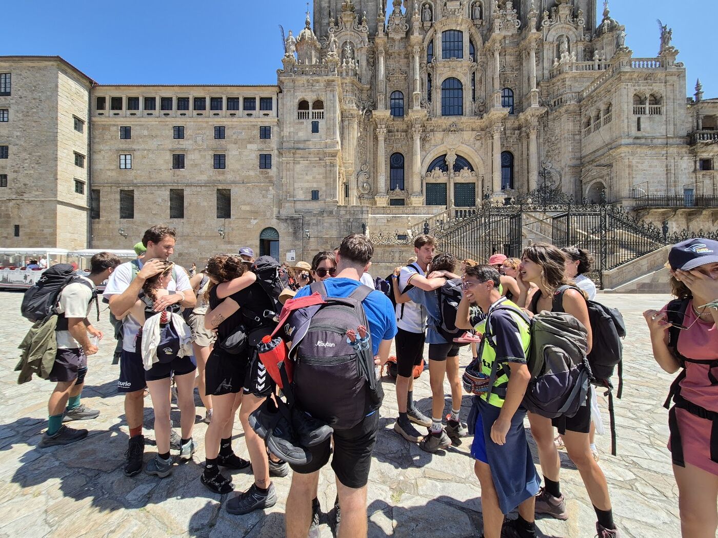 Pilgrims hugging in front of Santiago cathedral